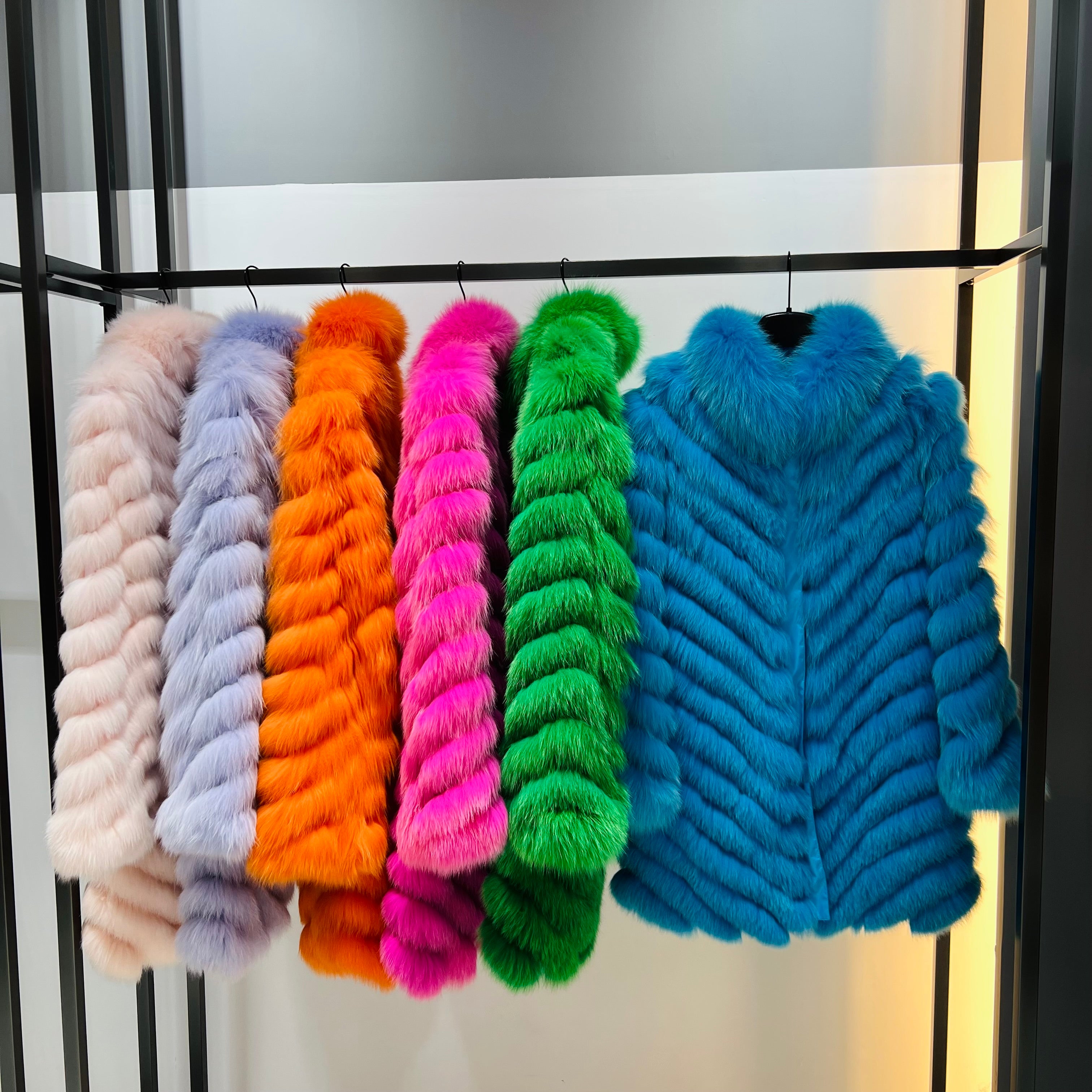 Colorful reversible fox fur ultra-light jackets in cream, lavender, orange, pink, green, and blue